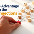 A hand positions a red block within an interconnected network of businesses, illustrating how understanding value chain relationships creates competitive advantage.