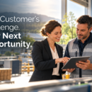 Business professionals collaborating in a manufacturing facility, illustrating how sustainability creates new customer opportunities and stronger supplier relationships.